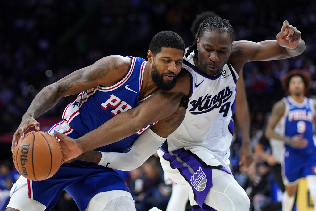 Philadelphia 76ers' Paul George, left, tries to get past Sacramento Kings' Precious Achiuwa during the second half of an NBA basketball game Thursday, Jan. 29, 2026, in Philadelphia. (AP Photo/Matt Slocum)