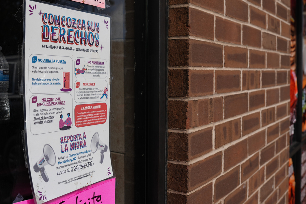 A sign in Spanish that reads at top: "Know Your Rights" is displayed outside of a restaurant store front, Thursday, Nov. 13, 2025, in Charlotte, N.C. (AP Photo/Matt Kelley)