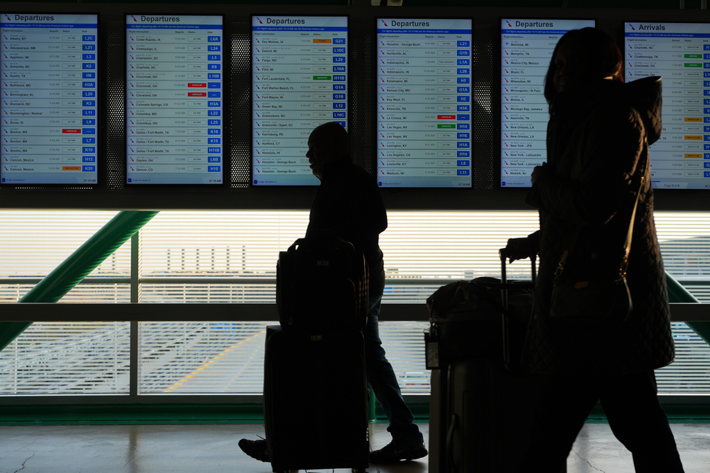 Travelers walk though the terminal at O'Hare International Airport in Chicago, Friday, Nov. 7, 2025. (AP Photo/Nam Y. Huh)