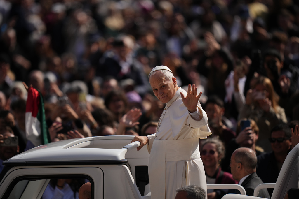 Pope Leo XIV greets faithful as he arrives in St. Peter's Square for the weekly general audience at the Vatican, Wednesday, March 25, 2026. (AP Photo/Alessandra Tarantino)