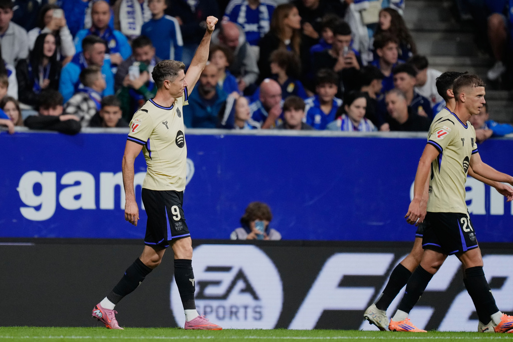 Barcelona's Robert Lewandowski celebrates his side's second goal during a Spanish La Liga soccer match at the Carlos Tartiere stadium in Oviedo, Spain, Thursday, Sept. 25, 2025. (AP Photo/Jose Breton)