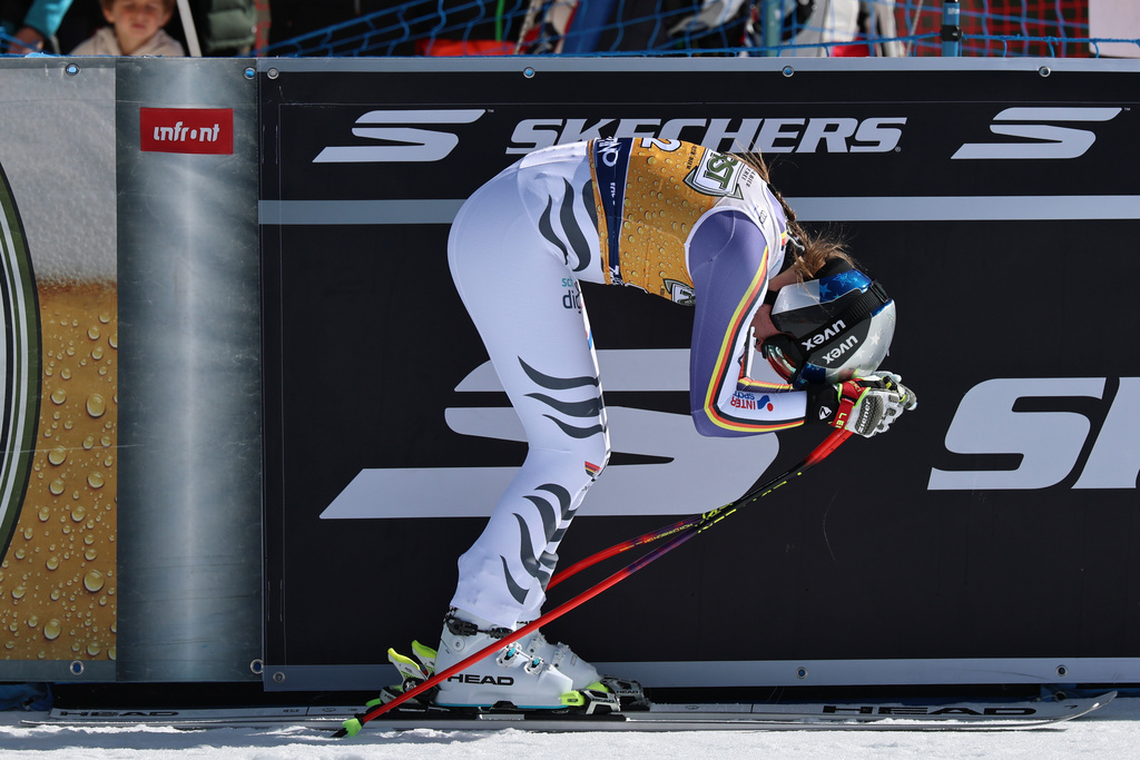 Germany's Emma Aicher reacts at the finish area of an alpine ski, women's World Cup downhill, in Val di Fassa, Italy, Saturday, March 7, 2026. (AP Photo/Marco Trovati)