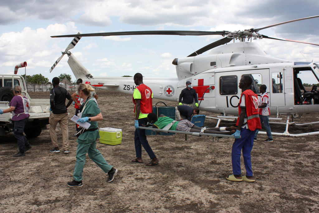 FILE - Medical staff with the International Committee of the Red Cross (ICRC) and South Sudan Red Cross, move a wounded patient to an ambulance in Akobo, South Sudan, May 24, 2025. (AP Photo/Joseph Falzetta, File)