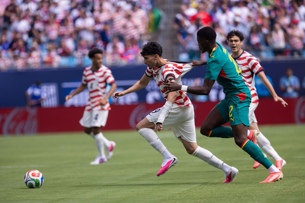 United States forward Ricardo Pepi, front left, is grabbed by Senegal defender Mamadou Sarr (2) during the first half of an international friendly soccer match Sunday, May 31, 2026, in Charlotte, N.C. (AP Photo/Scott Kinser)