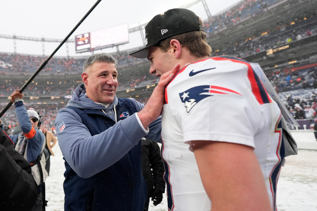 New England Patriots head coach Mike Vrabel speaks with quarterback Drake Maye after the AFC Championship NFL football game against the Denver Broncos, Sunday, Jan. 25, 2026, in Denver. (AP Photo/Ashley Landis)