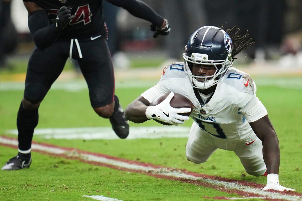 Tennessee Titans wide receiver Calvin Ridley (0) dives for extra yards after a catch during the second half of an NFL football game against the Arizona Cardinals, Sunday, Oct. 5, 2025, in Glendale, Ariz. (AP Photo/Rick Scuteri)