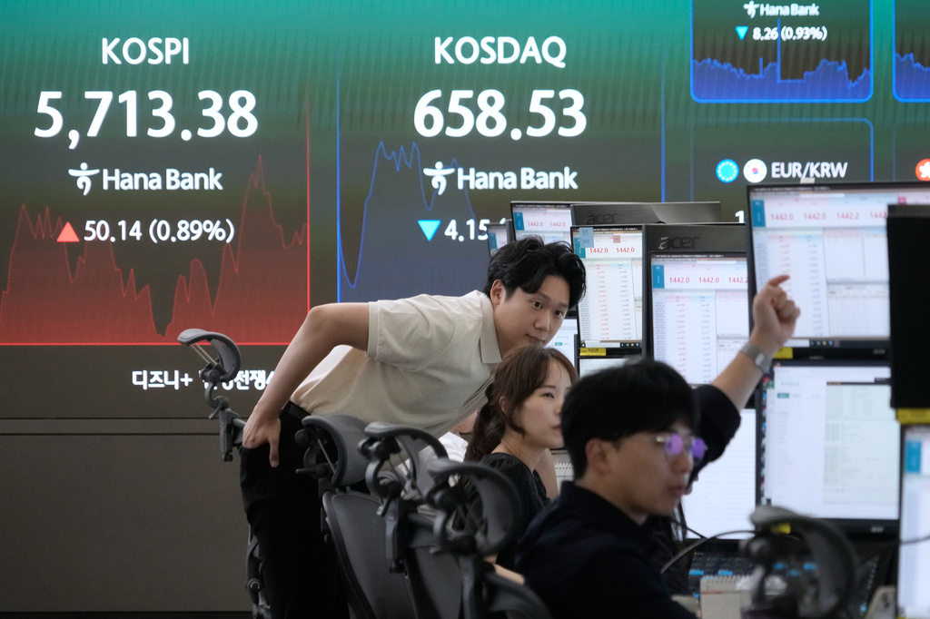 Currency traders watch monitors near a screen showing the Korea Composite Stock Price Index (KOSPI) at the foreign exchange dealing room of the Hana Bank headquarters in Seoul, South Korea, Thursday, July 30, 2026. (AP Photo/Ahn Young-joon)