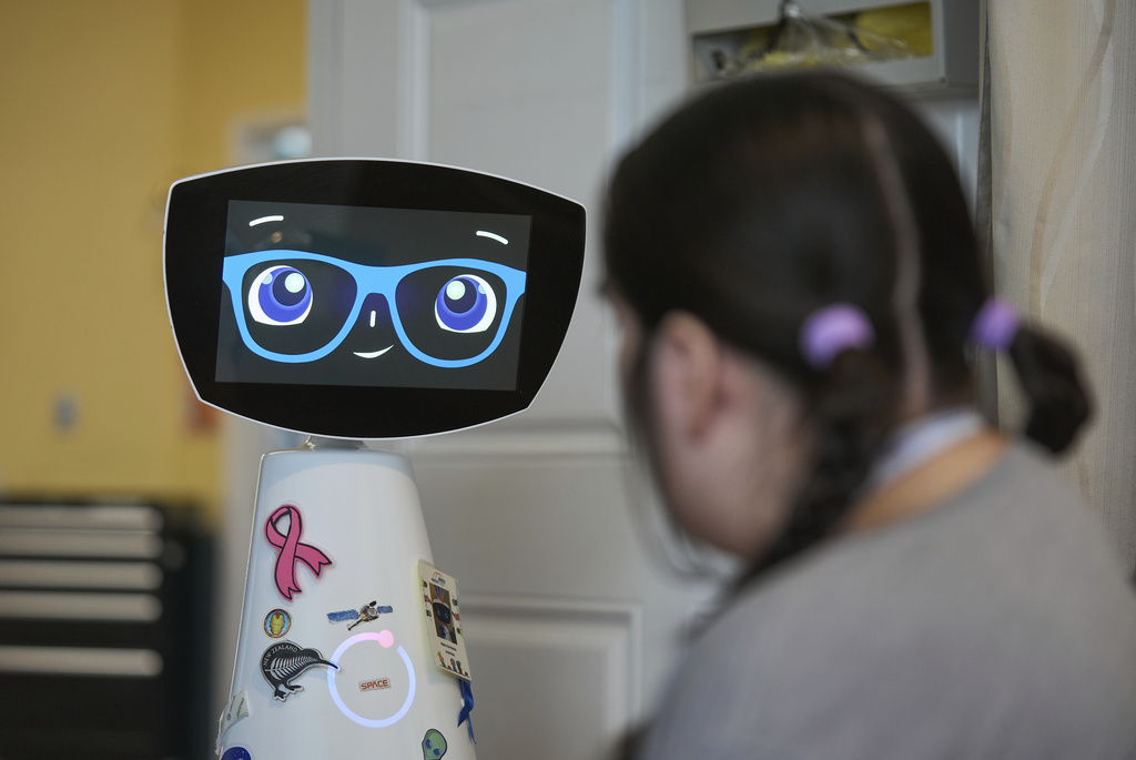 Robin the Robot visits with a patient at the HealthBridge Orange Specialty Pediatric Hospital in Orange, Calif., on Friday, Sept. 12, 2025. (AP Photo/Damian Dovarganes)
