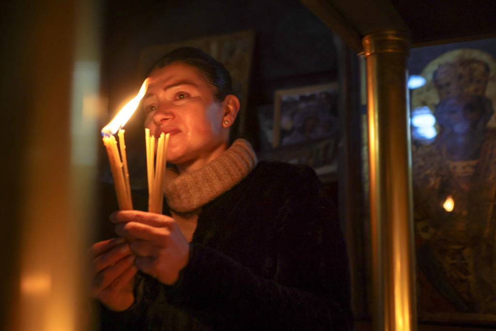 A woman holds candles as she attends an Orthodox service for the “sanctification of honey,” at the Presentation of the Blessed Virgin Church in the town of Blagoevgrad, Bulgaria, Tuesday, Feb. 10, 2026, marking the feast day of St. Haralambos, Orthodox patron saint of beekeepers. (AP Photo/Valentina Petrova)