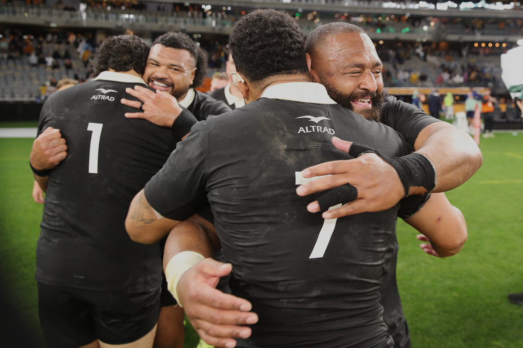 New Zealand's George Bower, right, embraces teammate Ardie Savea following the Bledisloe Cup rugby test between the All Blacks and the Wallabies in Perth, Australia, Saturday, Oct 4, 2025. (AP Photo/Gary Day)