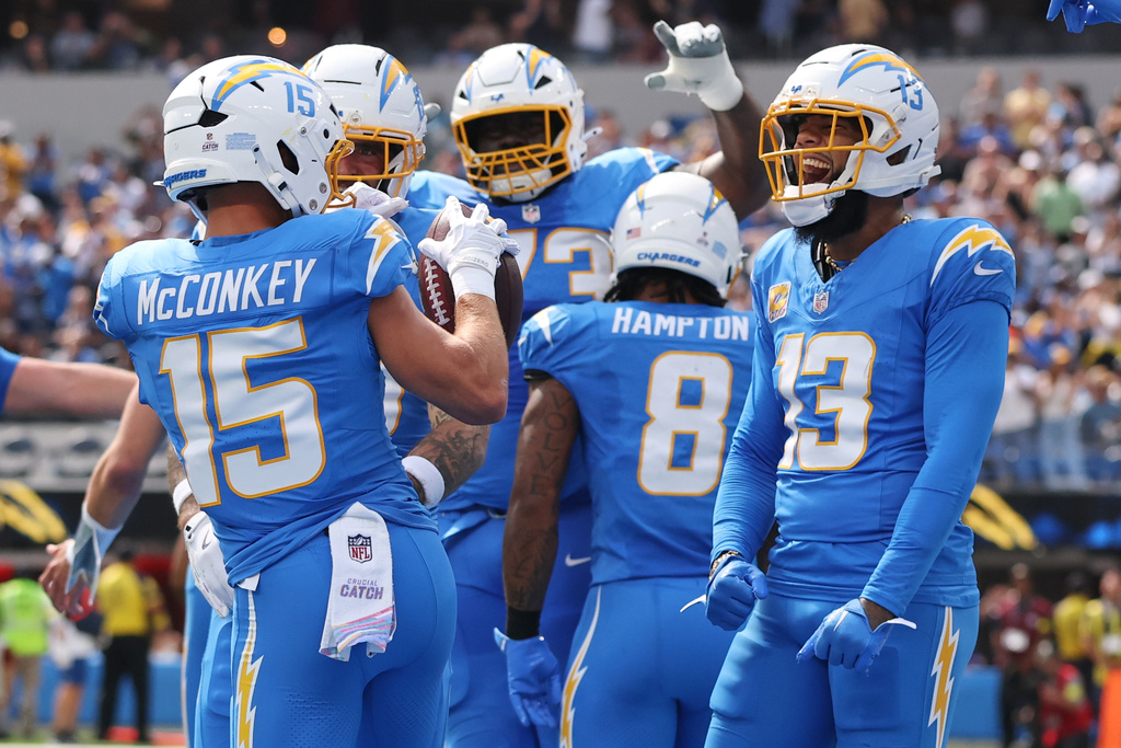 Los Angeles Chargers wide receiver Ladd McConkey (15) celebrates his touchdown catch with wide receiver Keenan Allen (13) during the first half of an NFL football game against the Washington Commanders, Sunday, Oct. 5, 2025, in Inglewood, Calif. (AP Photo/Eric Thayer)