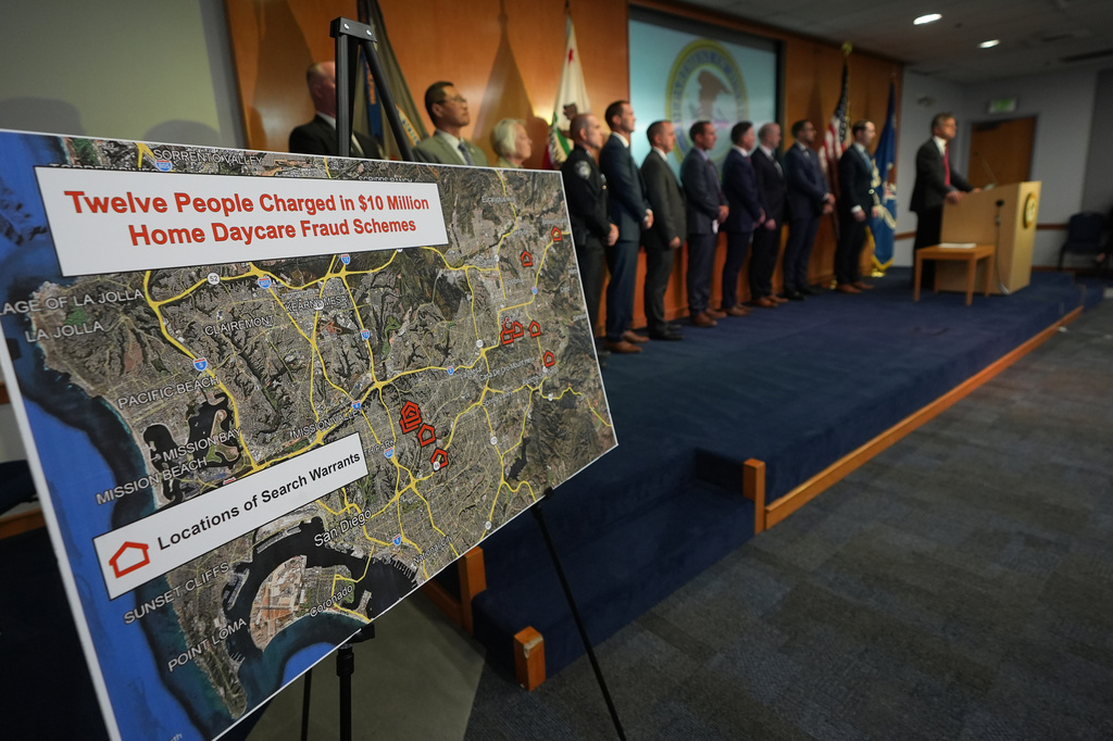 U.S. Attorney Adam Gordon announces charges against a dozen individuals for fraudulently collecting childcare payments during a press event, Tuesday, Sept. 15, 2026, in San Diego. (AP Photo/Gregory Bull)