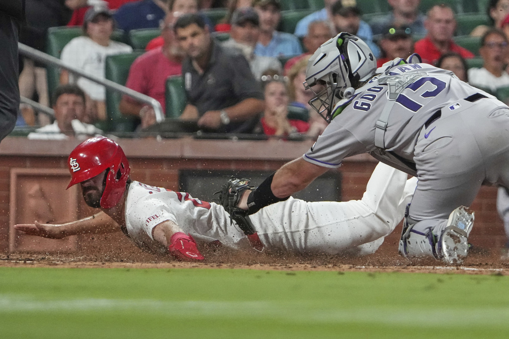 St. Louis Cardinals' Thomas Saggese, left, is tagged out by Colorado Rockies catcher Hunter Goodman during the sixth inning of a baseball game Monday, Aug. 11, 2025, in St. Louis. (AP Photo/Jeff Roberson)
