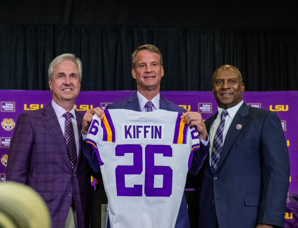 LSU president Wade Rousse and athletic director Verge Ausberry pose with new head football coach Lane Kiffin after an introductory news conference, Monday, Dec. 1, 2025, in Baton Rouge, La. (Michael Johnson/The Advocate via AP)