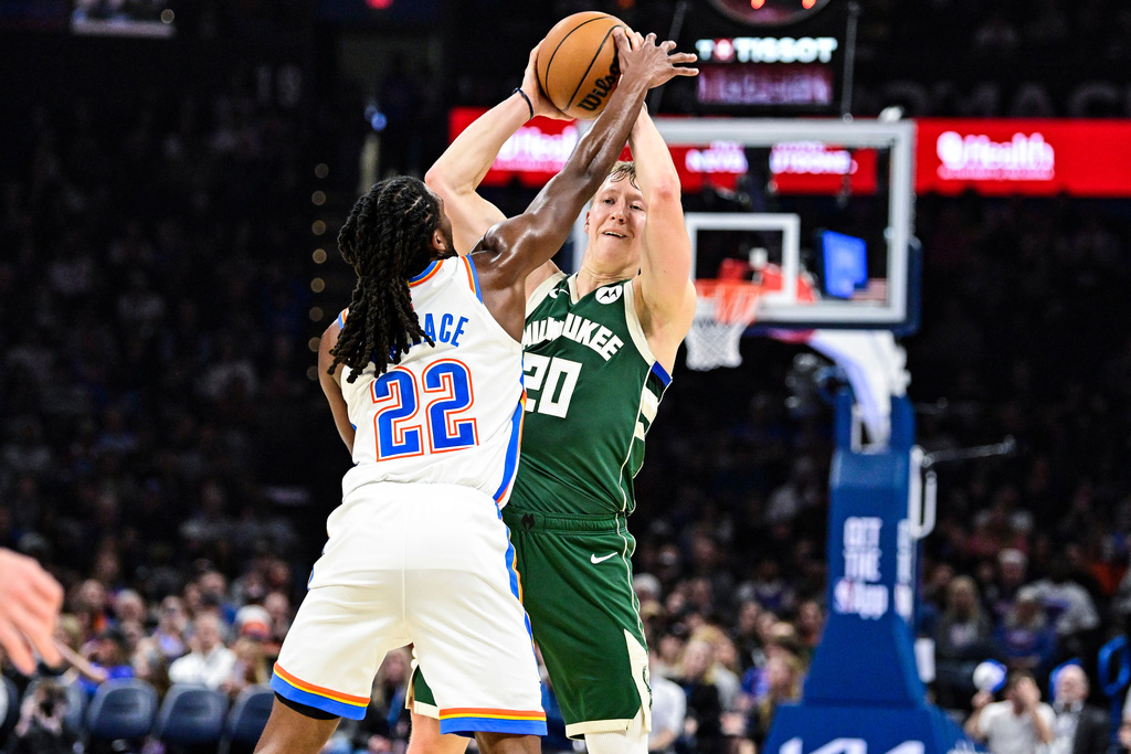 Milwaukee Bucks guard AJ Green (20) looks to pass against Oklahoma City Thunder guard Cason Wallace (22) during the first half of an NBA basketball game, Thursday, Feb. 12, 2026, in Oklahoma City. (AP Photo/Gerald Leong)