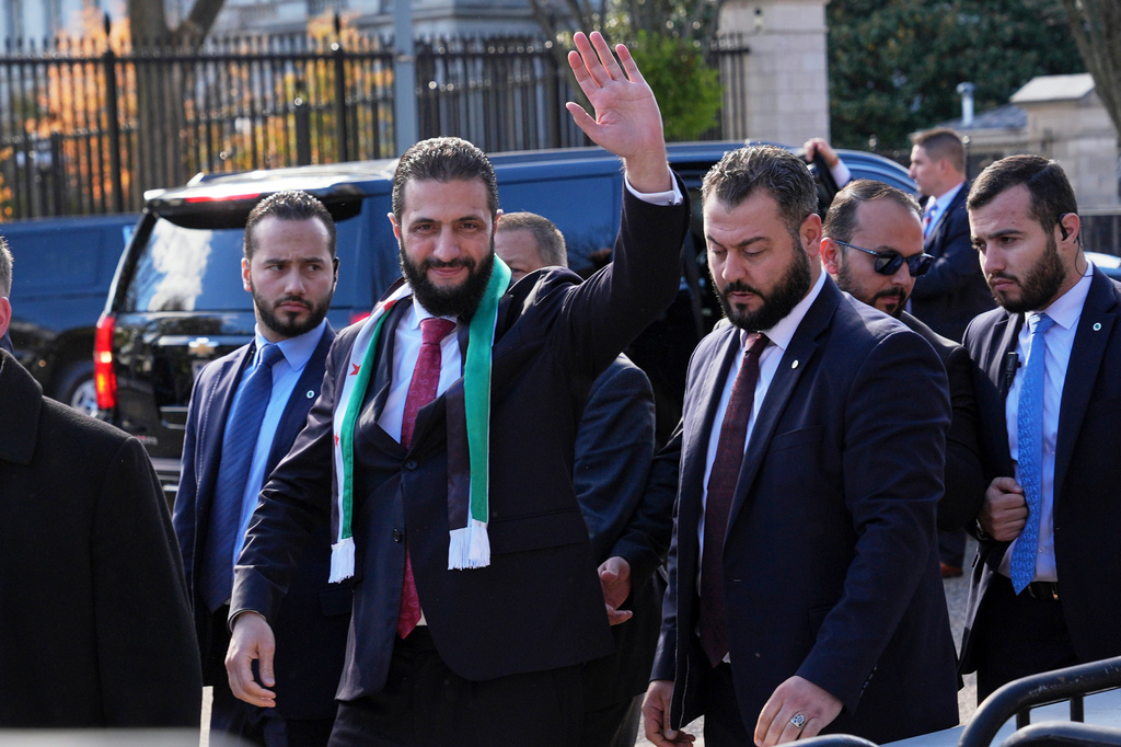 FILE - Syria's President Ahmed al-Sharaa waves as he greets supporters outside of the White House, Monday, Nov. 10, 2025, in Washington, following a meeting with President Donald Trump. (AP Photo/Jacquelyn Martin, File)