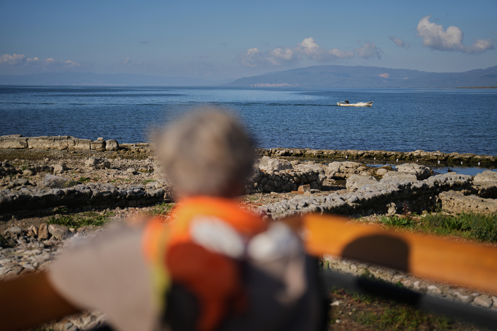 A man sails a boat next to archaeological excavations of the ancient Byzantine-era Christian Saint Neophytos Basilica, in Iznik, also known by its ancient name Nicaea, northwestern Turkey, Thursday, Nov. 13, 2025, ahead of the visit of Pope Leo XIV to mark the 1,700th anniversary of the First Council of Nicaea. (AP Photo/Francisco Seco)