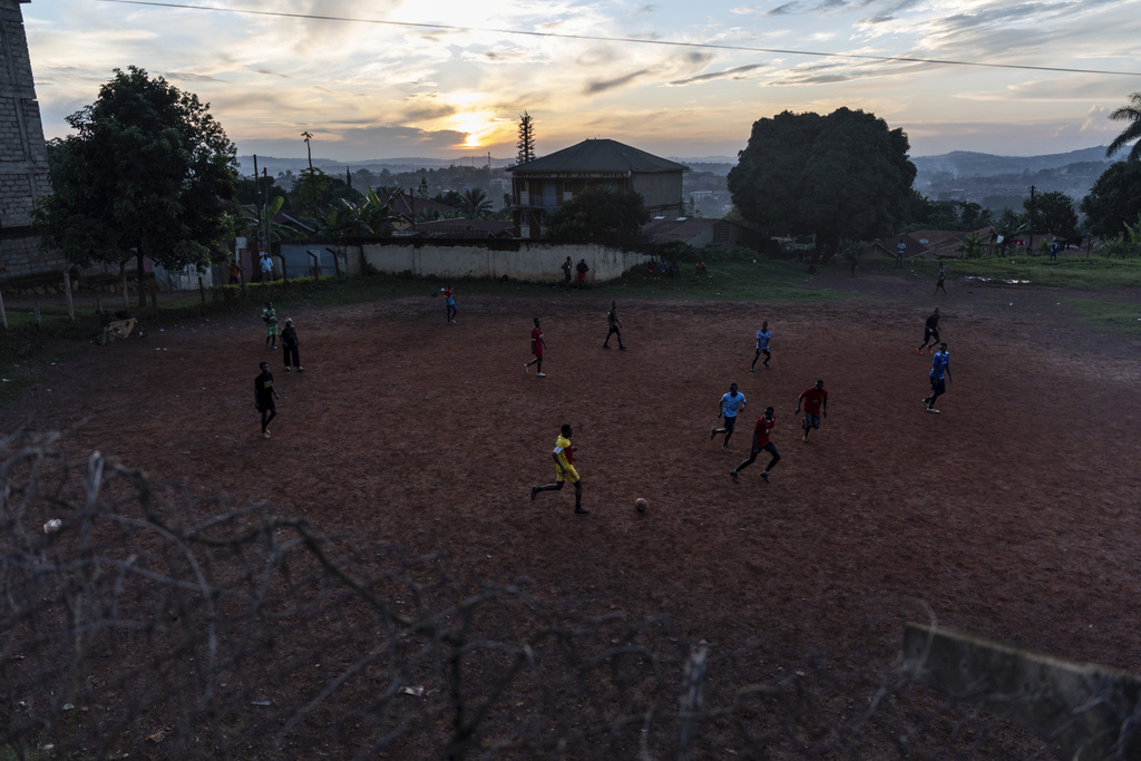 Youths play soccer at sunset, Saturday, Nov. 23, 2024, in Mukono, Uganda, home to one of the world's youngest populations, where half of its people are under 18 years old. (AP Photo/David Goldman)