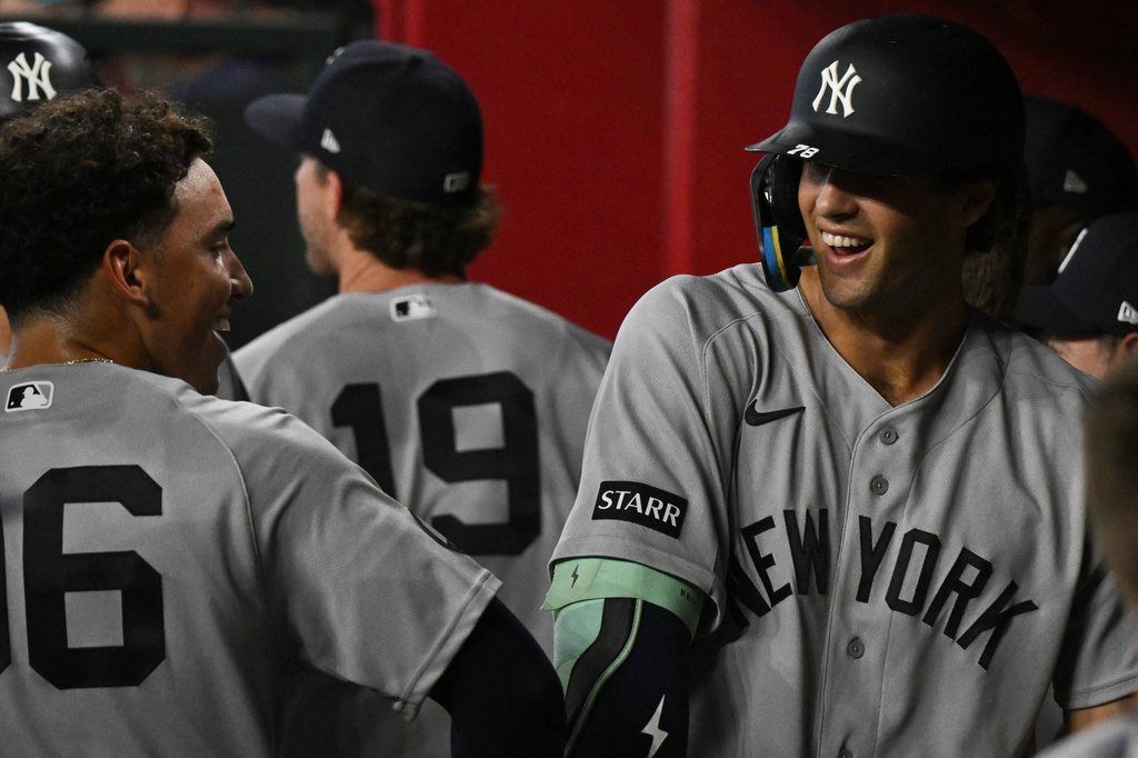 New York Yankees' George Lombard Jr., left, celebrates with Spencer Jones, right, after they hit home runs during the third inning of a baseball game against the Arizona Diamondbacks, Sunday, Sept. 20, 2026, in Phoenix. (AP Photo/Caitlin O'Hara)