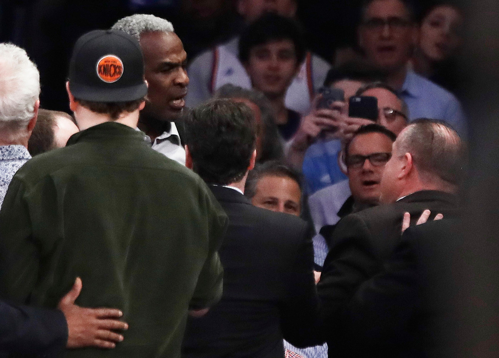 FILE - Former New York Knicks player Charles Oakley, rear left, exchanges words with a security guard during the first half of an NBA basketball game between the Knicks and the Los Angeles Clippers in New York on Feb. 8, 2017. (AP Photo/Frank Franklin II, File)