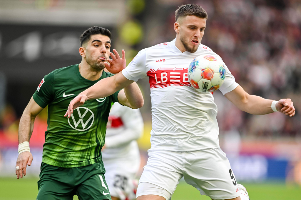 Wolfsburg's Konstantinos Koulierakis, left, in action against Stuttgart's Ermedin Demirovic during the German Bundesliga soccer match between VfB Stuttgart and VfL Wolfsburg in Stuttgart, Germany, Sunday, March 1, 2026. (Harry Langer/dpa via AP)
