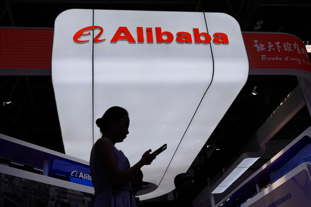 FILE - A visitor walks in front of Alibaba booth during the 3rd China International Supply Chain Expo at the China International Exhibition Center, in Beijing, China, Friday, July 18, 2025. (AP Photo/Mahesh Kumar A., File)