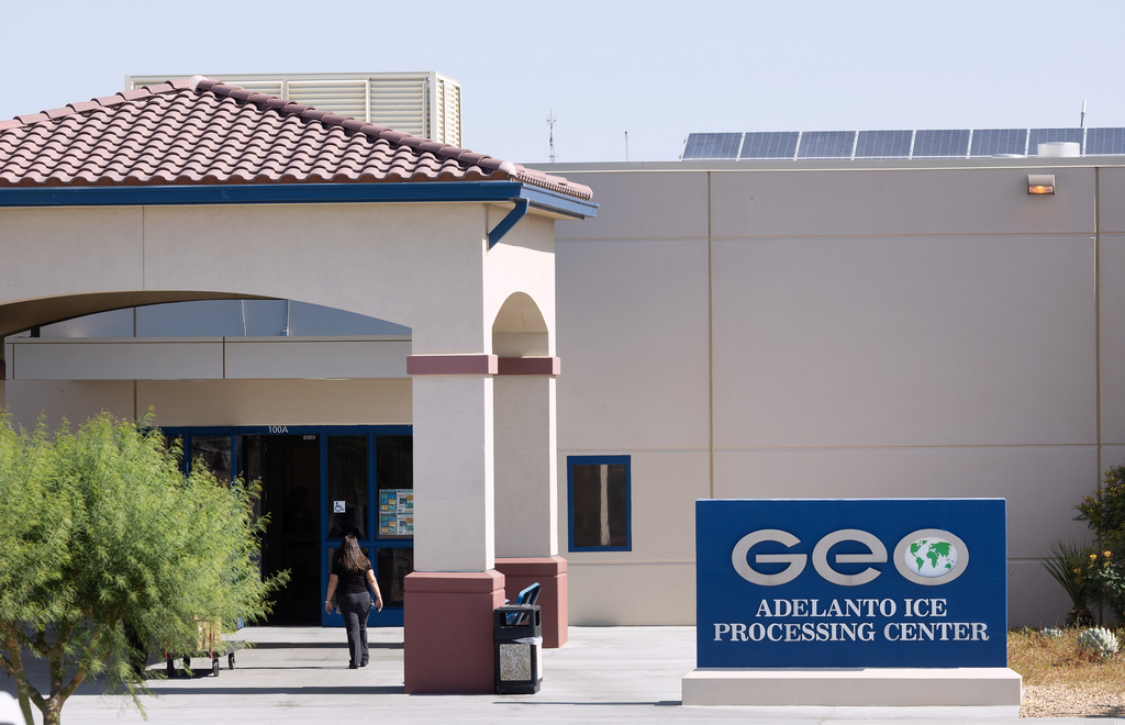 A person walks near the entrance of the GEO Adelanto ICE Processing Center in Adelanto, Calif. on June 17, 2025. (Myung J. Chun/Los Angeles Times via AP)