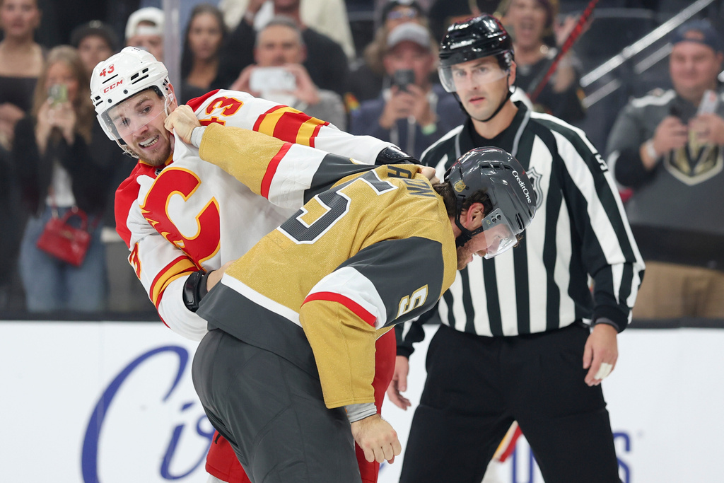 Calgary Flames right wing Adam Klapka (43) and Vegas Golden Knights defenseman Jeremy Lauzon (5) fight during the first period of an NHL hockey game Saturday, Oct. 18, 2025, in Las Vegas. (AP Photo/Ian Maule)