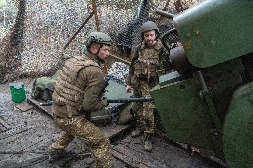 Soldiers from Ukraine's Khartia brigade fire a canon towards Russian army positions near Kharkiv, Ukraine, Thursday, May 14, 2026. (AP Photo/Andrii Marienko)