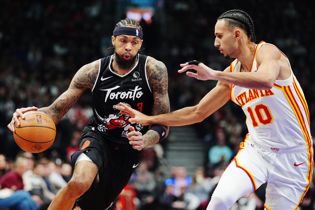 Toronto Raptors' Brandon Ingram (3) drives at Atlanta Hawks' Zaccharie Risacher (10) during the first half of an NBA basketball game in Toronto, Saturday, Jan. 3, 2026. (Frank Gunn/The Canadian Press via AP)