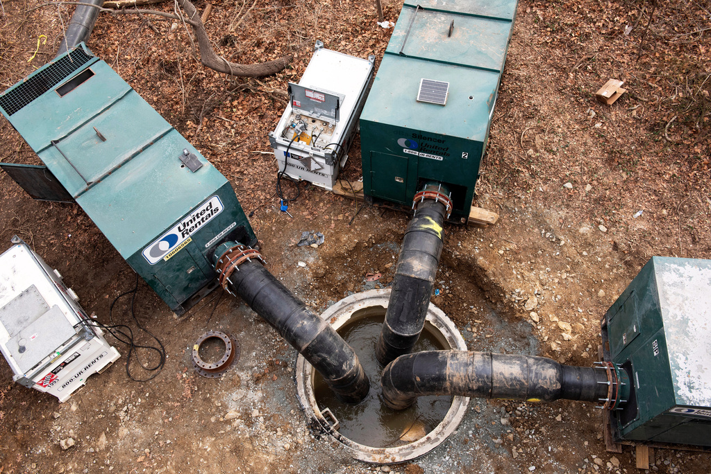 Interceptor pipes inserted into raw sewage after a massive pipe rupture has sent sewage spilling into the Potomac River, in Glen Echo, Md., Friday, Jan. 23, 2026. (AP Photo/Cliff Owen)