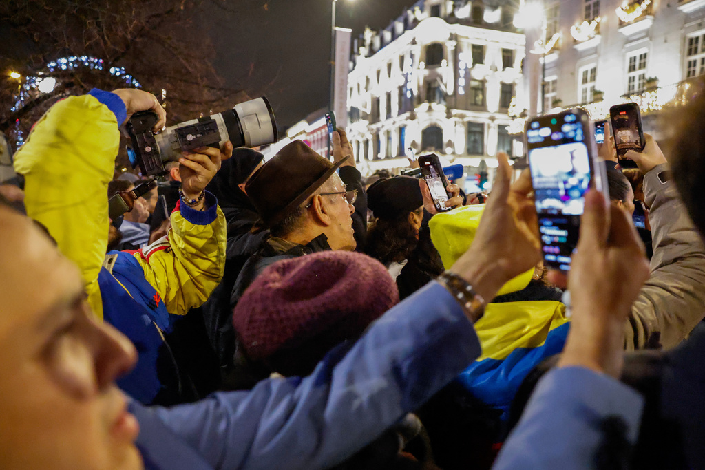 People wait to see Nobel Peace Prize laureate Maria Corina Machado outside the Grand Hotel, in Oslo, Norway, early Thursday, Dec. 11, 2025. (Jonas Been Henriksen/NTB Scanpix via AP)