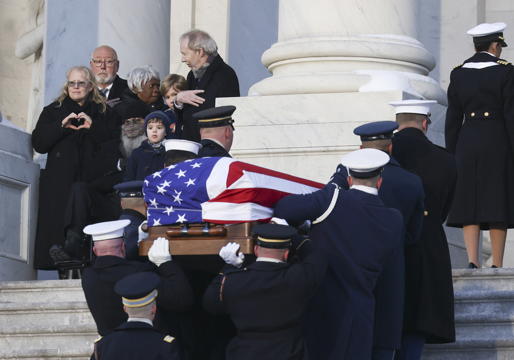 A joint services military body bearer team carries the flag-draped casket of former President Jimmy Carter up the steps into the U.S Capitol, Tuesday, Jan. 7, 2025, in Washington. Carter died Dec. 29 at the age of 100. (Evelyn Hockstein/Pool via AP)