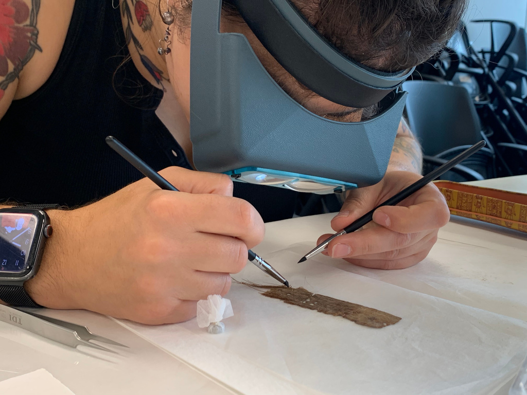 Papyrus Conservation Summer Seminar student Mimi Zycherman examines a papyrus fragment at the University of Michigan Thursday, Aug. 6, 2026, in Ann Arbor, Mich. (AP Photo/Mike Householder)