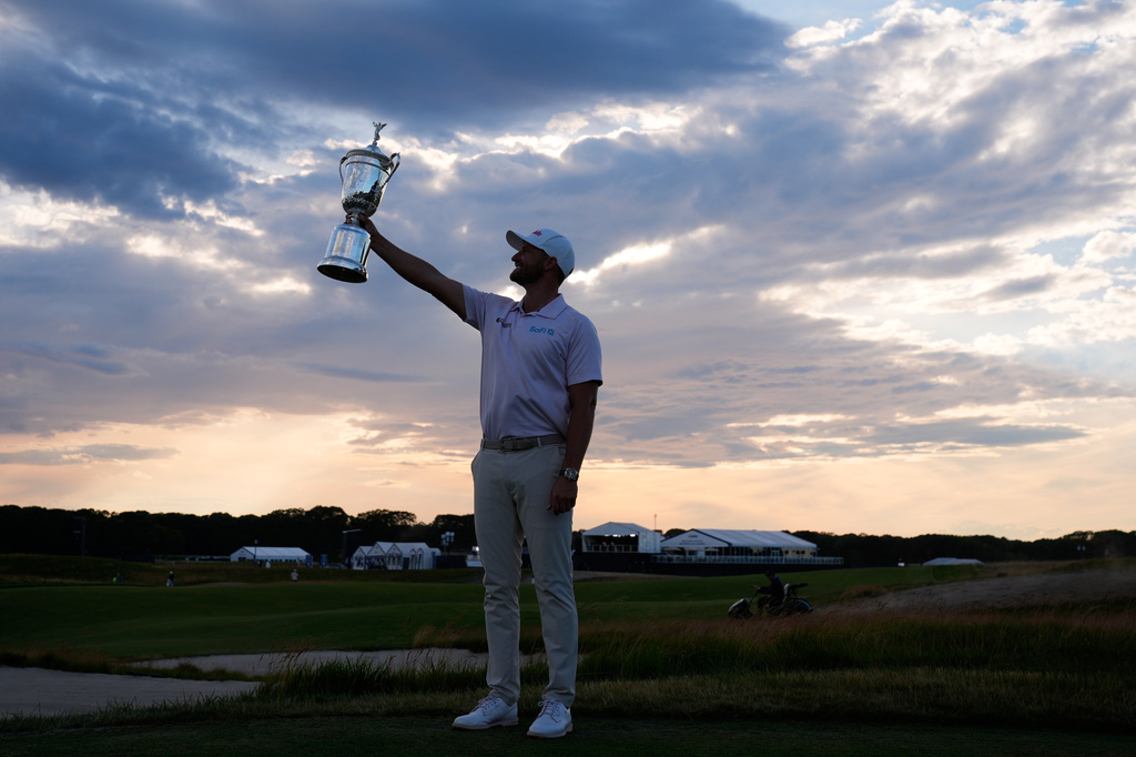 Wyndham Clark holds the trophy after winning the U.S. Open golf tournament at Shinnecock Hills Golf Club in Southampton, N.Y., Sunday, June 21, 2026. (AP Photo/Seth Wenig)