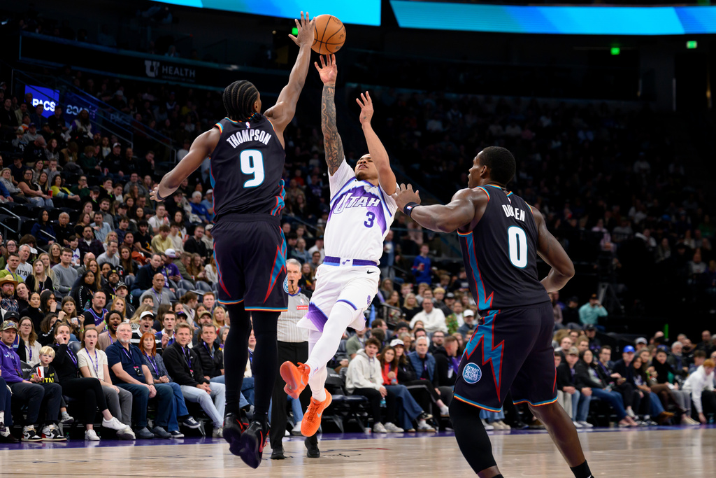 Utah Jazz guard Keyonte George (3) shoots over Detroit Pistons guard Ausar Thompson (9) during the second half of an NBA basketball game, Friday, Dec. 26, 2025, in Salt Lake City. (AP Photo/Tyler Tate)