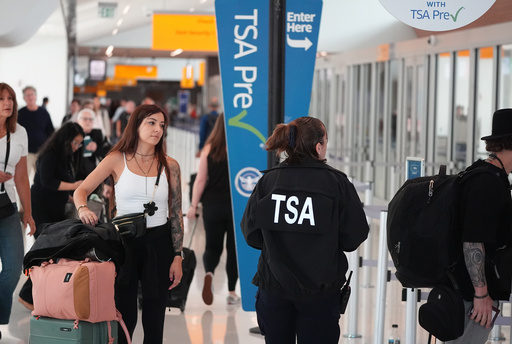 Transportation Security Administration worker guides travelers at a security checkpoint in Denver International Airport Thursday, Oct. 2, 2025, in Denver. (AP Photo/David Zalubowski) Transportation Security Administration worker guides travelers at a security checkpoint in Denver International Airport Thursday, Oct. 2, 2025, in Denver. (AP Photo/David Zalubowski)