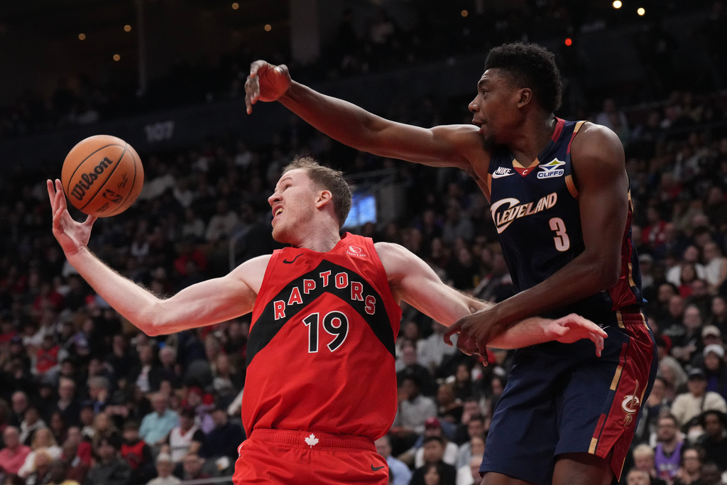 Toronto Raptors center Jakob Poeltl (19) collects a defensive rebound from Cleveland Cavaliers center Thomas Bryant (3) during the first half of an NBA basketball game in Toronto on Monday Nov. 24, 2025. (Chris Young/The Canadian Press via AP)