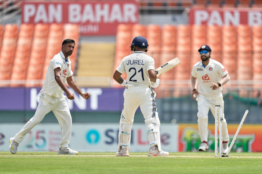 India's Dhruv Jurel, center, is bowled out by Afghanistan's Mohammad Saleem, left, on day two of the cricket test match between Afghanistan and India in New Chandigarh, India, Sunday, June 7, 2026. (AP Photo/Ashwini Bhatia)