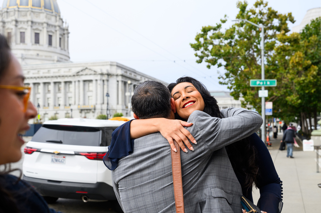 Plaintiff Clarissa Cervantes hugs a legal team member before attending a hearing about Riverside County Sheriff Chad Bianco's seizure and recount of more than half a million 2025 election ballots on Monday, Aug. 24, 2026, in San Francisco. (AP Photo/Noah Berger)