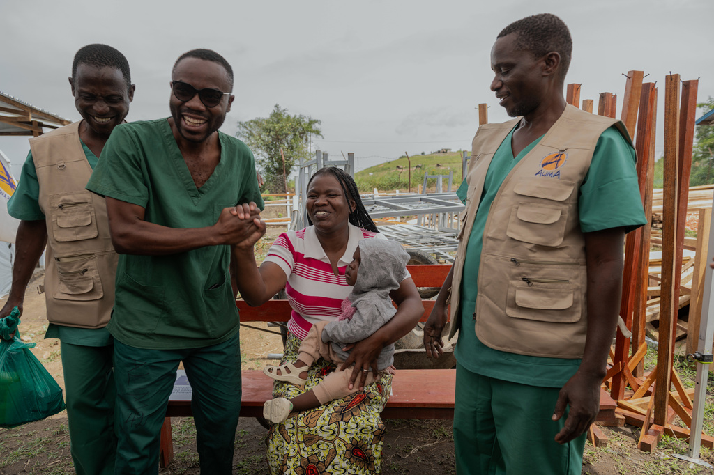 Kahindo Mireille Pierrette, an Ebola survivor, center, poses with her 16-month old baby and health workers after they were declared to have survived Ebola and discharged from the Rwampara treatment Center in Ituri Congo, Tuesday, June 16, 2026. (AP Photo/Moses Sawasawa)