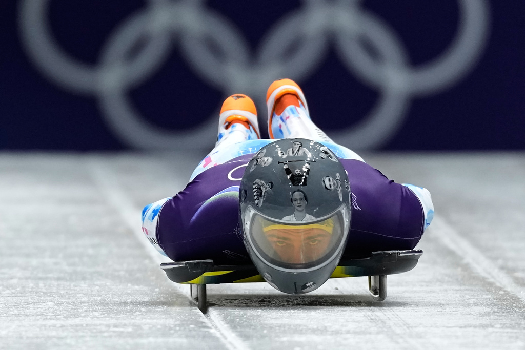 Ukraine's Vladyslav Heraskevych starts for a men's skeleton training session at the 2026 Winter Olympics, in Cortina d'Ampezzo, Italy, Wednesday, Feb. 11, 2026. (AP Photo/Aijaz Rahi)