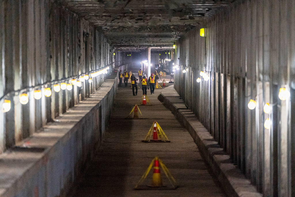 FILE - Metropolitan Transportation Authority workers are seen during a media tour of subway tunnels built in the 1970s that will be part of the Second Ave Subway expansion project, Nov. 23, 2021, in New York. (AP Photo/Mary Altaffer, File)