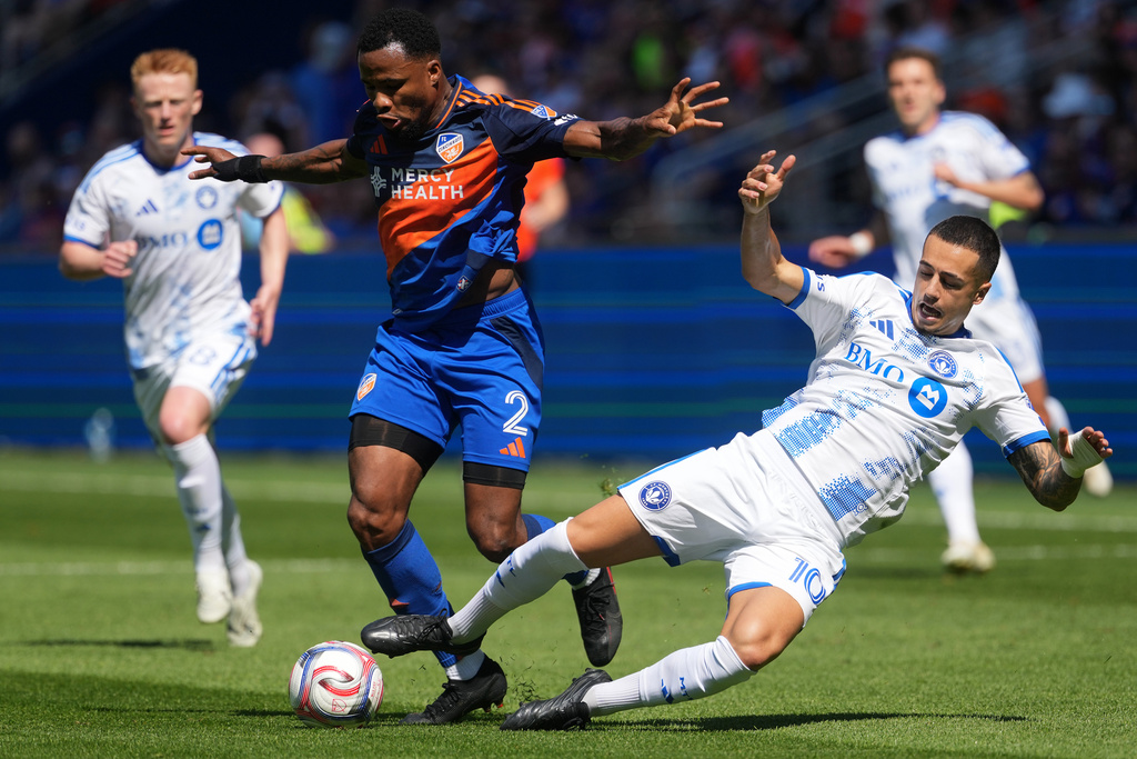 FC Cincinnati defender Alvas Powell (2) takes the ball from CF Montréal midfielder Iván Jaime (10) during the first half of an MLS soccer match, Sunday, March 22, 2026, in Cincinnati. (AP Photo/Kareem Elgazzar)
