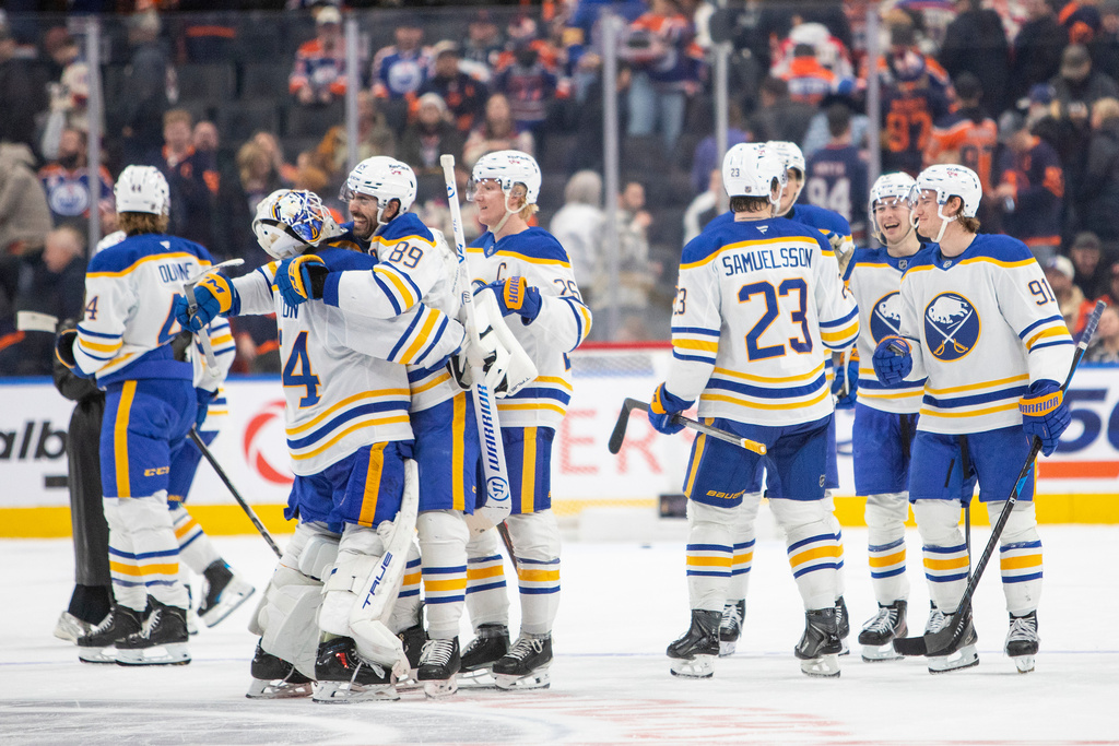 Buffalo Sabres Alex Tuch (89) hugs goalie Alex Lyon (34) as they celebrate the game-winning goal against the Edmonton Oilers during overtime in an NHL hockey game in Edmonton, Alberta, Tuesday, Dec. 9, 2025. (Amber Bracken/The Canadian Press via AP)