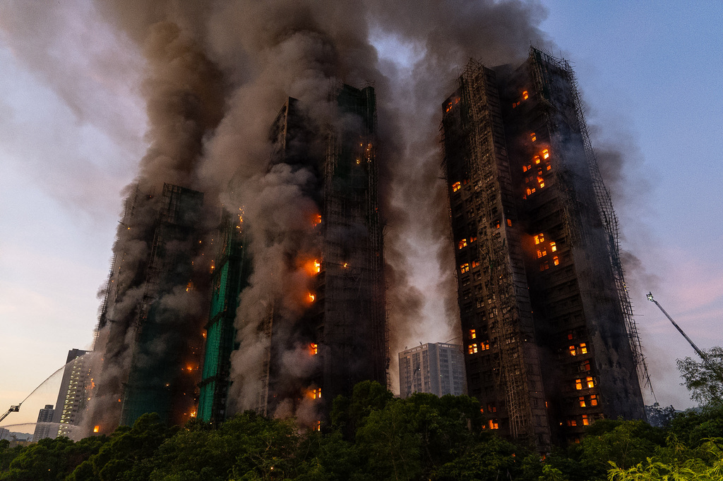FILE - Smoke rises after a fire broke out at Wang Fuk Court, a residential estate in the Tai Po district of Hong Kong's New Territories, Nov. 26 2025. (AP Photo/Chan Long Hei, File)