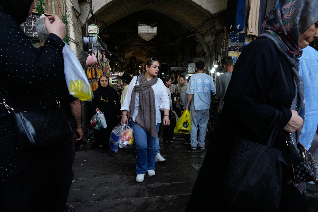 People walk at Tehran's traditional main bazaar, Iran, Saturday, Aug. 8, 2026. (AP Photo/Vahid Salemi)