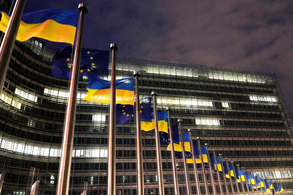 FILE - The European Union and Ukrainian flags flap in the wind to mark the third anniversary of Russia's full-scale invasion of Ukraine outside EU headquarters in Brussels, Feb. 24, 2025. (AP Photo/Virginia Mayo, File)