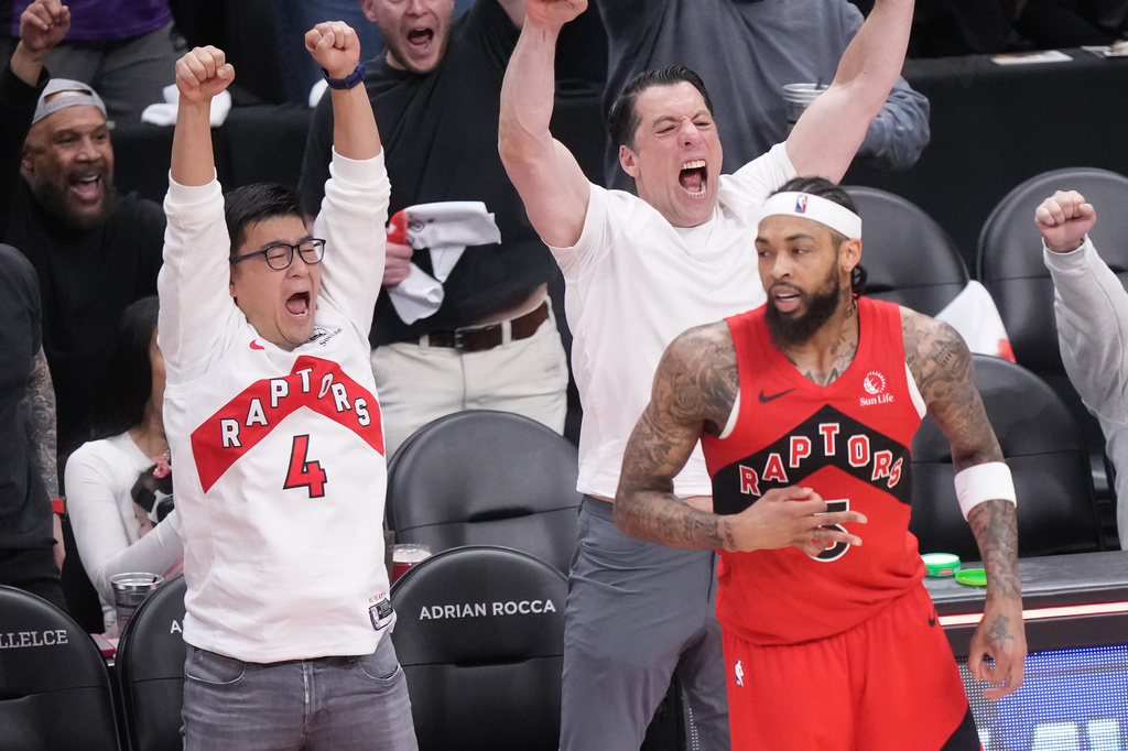 Fans react after Toronto Raptors forward Brandon Ingram, front, made a 3-point basket in the final minutes of the first half of Game 4 in a first-round NBA basketball playoffs series against the Cleveland Cavaliers in Toronto, Sunday, April 26, 2026. (Nathan Denette/The Canadian Press via AP)