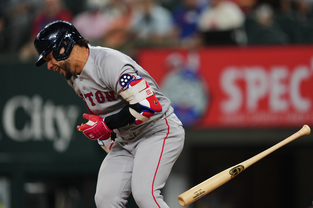 Boston Red Sox's Willson Contreras drops his bat after being hit by a pitch thrown by Texas Rangers' Nathan Eovaldi in the sixth inning of a baseball game Wednesday, Sept. 16, 2026, in Arlington, Texas. (AP Photo/Tony Gutierrez)